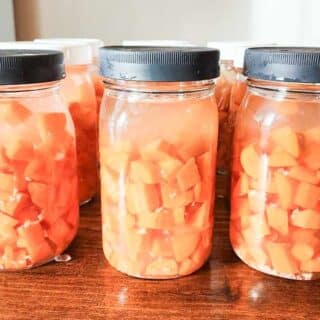 Fermented carrots in glass mason jars on a counter top