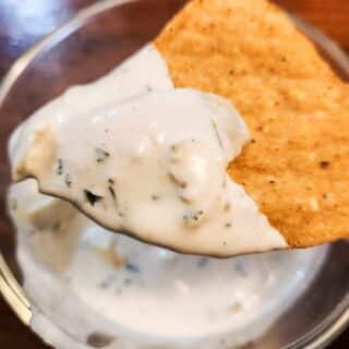 homemade creamy milk kefir artichoke spinach dip on a corn chip