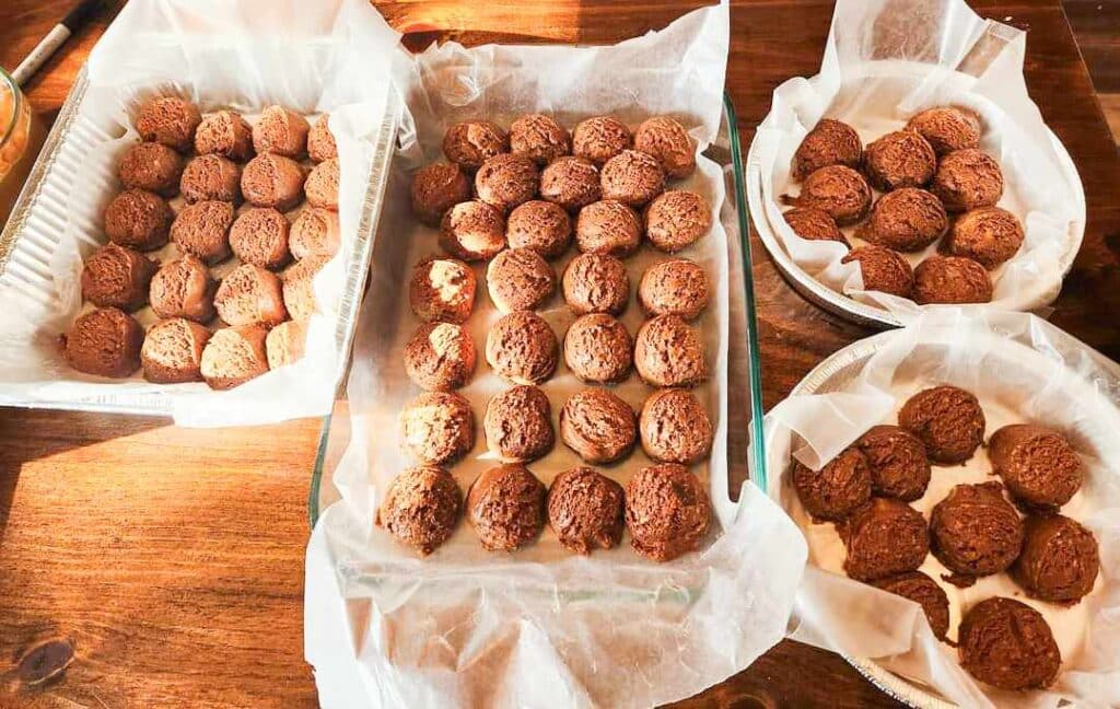 energy bites in pans on parchment paper on counter