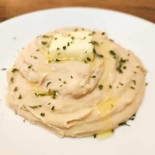 whipped white navy bean gaps diet mashed potatoes with butter and herbs on a plate