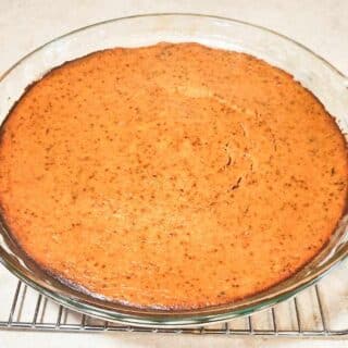 healthy pumpkin pie cooling on pie rack