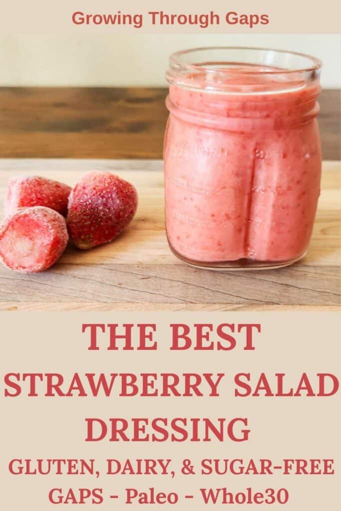 the best strawberry salad dressing- gluten, dairy, and sugar free, gaps whole30, and paleo - strawberry salad dressing in a half pint jar with frozen strawberries presented on a cutting board