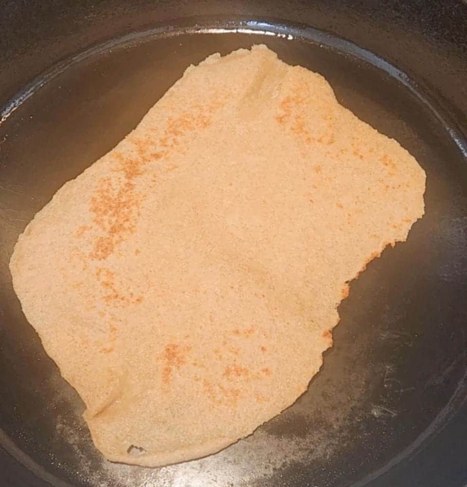 fresh milled flour tortilla cooked in cast iron pan with milled hard white wheat berries