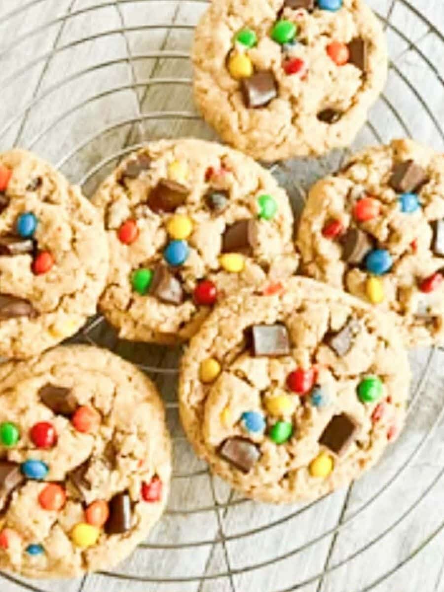 gluten, dairy, and sugar free monster cookies presented on a wire rack with chocolate chunks and MnMs